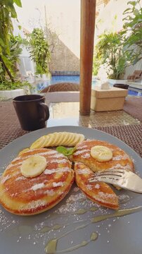 Tropical Breakfast With Banana Pancakes And Coffee Beside Resort Pool, Relaxing Morning Atmosphere, Leisure Travel Lifestyle And Vacation Comfort