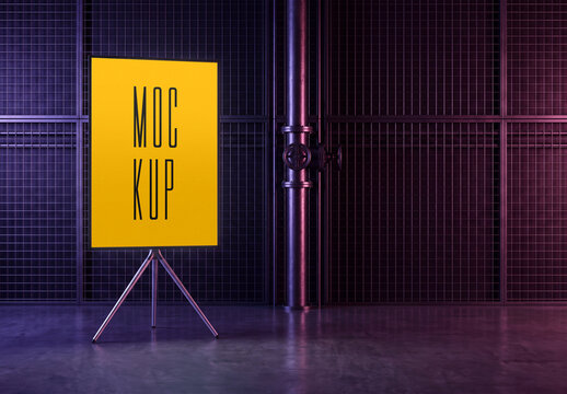 Eye-level perspective view of a vertical poster mockup on a metallic tripod stand in an industrial dark interior room with metal pipes and grid walls