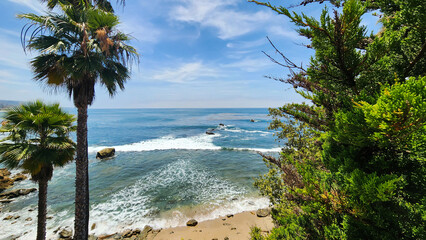 Scenic Coastline View of Laguna Beach California with Turquoise Ocean Waves and Sand at Golden Hour © VEVELOX
