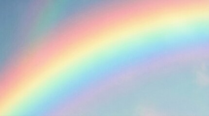 Fototapeta premium Multicolored rainbow arching across pale sky at horizon