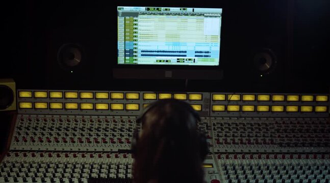 Sound Engineer Working at Recording Studio Mixing Console