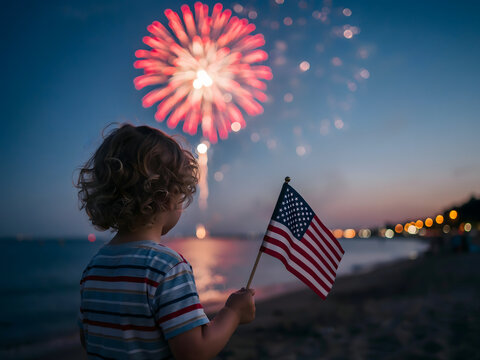 Toddler watching pink fireworks display on beach holding american flag at sunset.