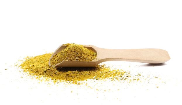 Shawarma seasoning pile (shoarma), middle eastern spice blend, isolated on white background, (organic coriander, cumin, white onion granules, garlic granules, bay leaf, black pepper, turme), side view