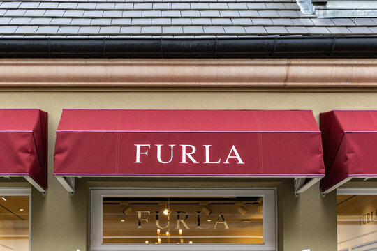 Furla Storefront with Red Awning at La Vallee Village, France.