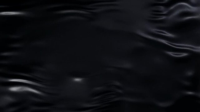Dynamic waves on black surface creating mesmerizing fluid patterns in motion