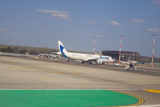 FlyOne passenger aircraft parked on the apron at Chisinau International Airport during ground operations - Chisinau, Moldova March 16 2026.