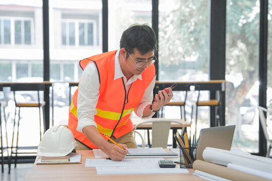 Engineer and Architect Reviewing Interior Design Plans in Office