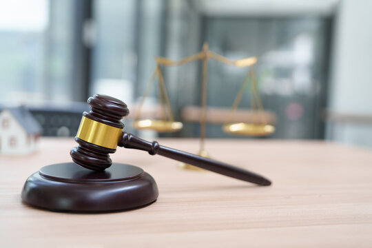 Wooden Gavel and Scales of Justice in an Office Setting for Legal Representation