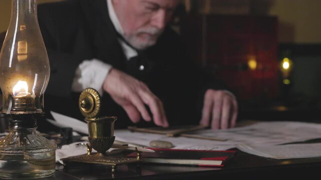 Focus on oil lamp shipwright using a wooden level and protractor