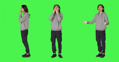 Obraz premium Man sending air kisses on camera, acting flirty and cute standing against green screen background, with young adult feeling confident and romantic showing true sweet emotions.