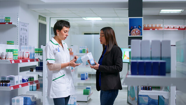 Shopper feeling unwell visiting pharmacy, looking to find pharmaceutical drugs to cure nauseating headache, asking certified healthcare practitioner for recommendations.