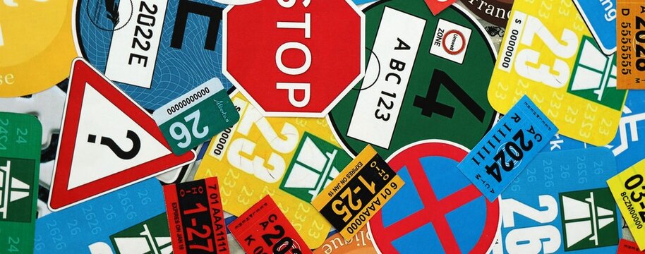 Pattern of traffic and road signs including warning symbols, Swiss and German vignettes