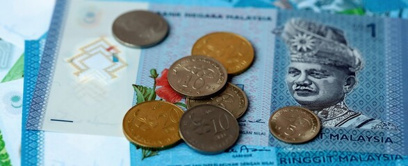 Malaysian ringgit money bills and coins on table. Malaysia cash of MYR currency close up © Larysa