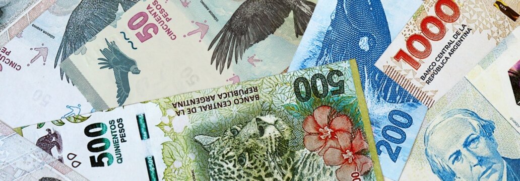 Argentine peso money banknotes bunch on table. Argentina bills of ARS currency close up