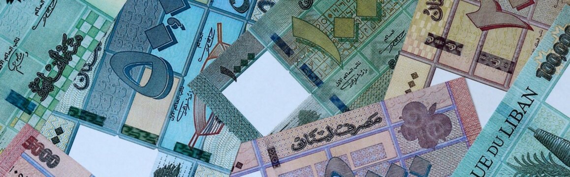 Lebanese pound money bills in pile on table. Lebanon LBP currency cash close up