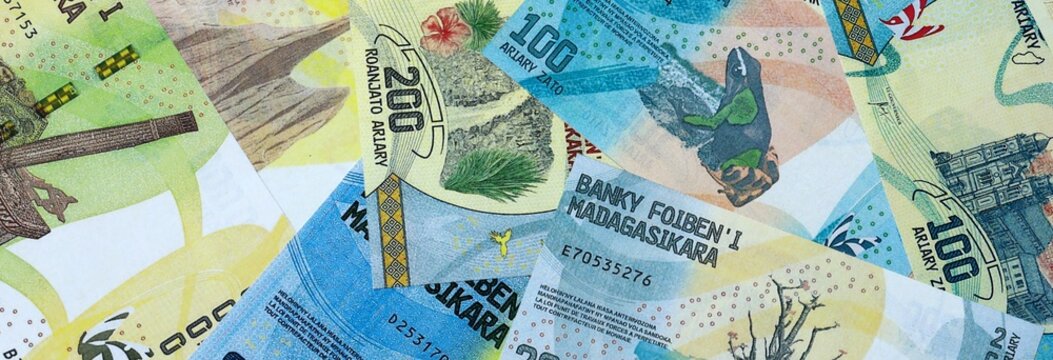 Malagasy ariary money bills in pile on table. Madagascar MGA currency cash close up