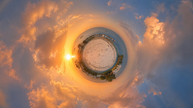 AI generated tiny planet panorama coastal landscape dramatic clouds glowing sunset creating surreal perspective travel inspiration environmental wonder