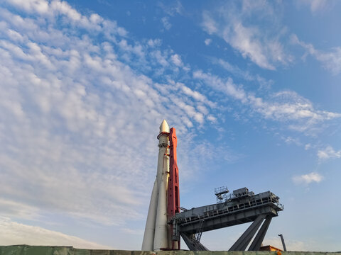 Rocket landing with platform on the launch pad on blue sky background