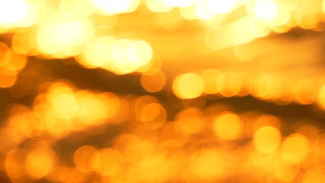 Bokeh reflection water golden bokeh circles dancing on water surfaces creating a warm shimmering atmosphere