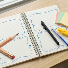 Naklejka premium Spiral notebook open on a wooden surface displays hand-drawn doodle frames for organizing important daily tasks.