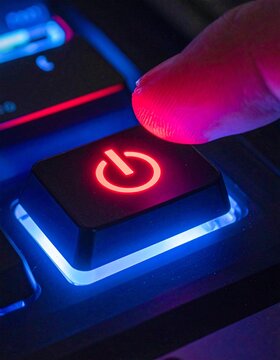 Finger presses glowing power button