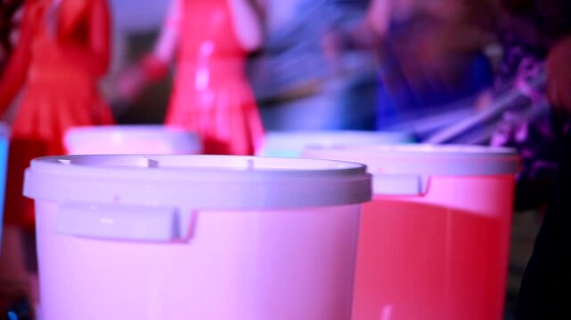 Epic performance of drummers on illuminated drums. Drum show. Drum ensemble. Close-up