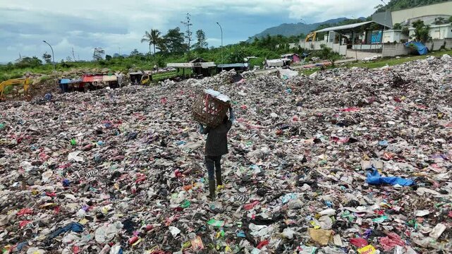 Drone Following Shot of Waste Picker Working at Mekarsari Landfill in West Java Indonesia
