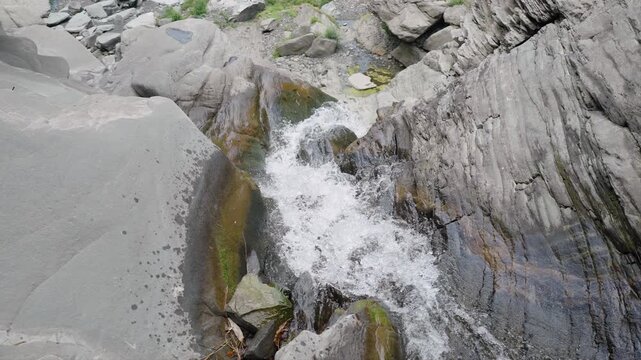 High angle view of clear water stream flowing over rocks in mountain wilderness