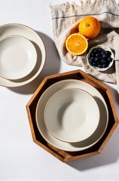 Ceramic dinnerware set on wooden tray with fresh oranges and blueberries for healthy breakfast cafe menu and food advertising