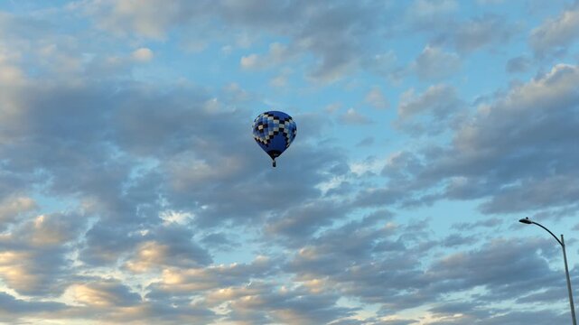 Blue checkered pattern hot air balloon flying high cloudy sky background conceptual freedom cloud computing data tracking growth travel adventure