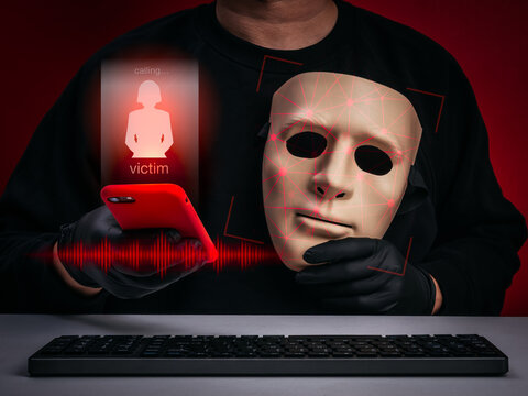 Scammer using AI deepfake technology with fake face and voice cloning through smartphone to deceive victims. AI impersonation, scam calls, phishing attacks, online fraud and cybercrime threats.