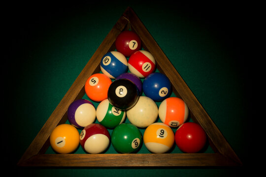 billiard table with balls
COLORFUL BILLIARD BALLS ARRAGED IN TRIANGLE RACK ON POOL TABLE