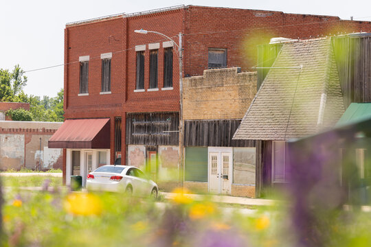 Flowers frame historic architecture along a city street in downtown Yale, Oklahoma, USA.