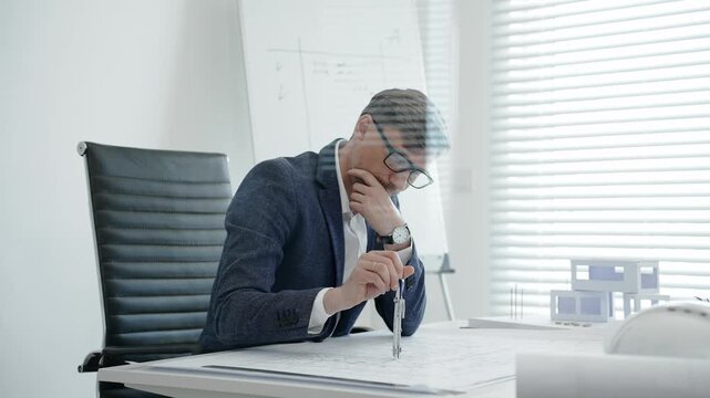 Experienced male architect working on blueprints at his desk, carefully measuring and planning intricate details for a contemporary architectural project, surrounded by a scale model