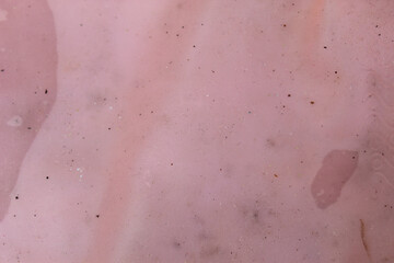 Fototapeta premium Crumpled pink rubber texture background with small dirt details and stain spots.