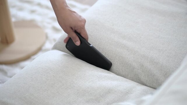 Finding a phone in the couch at home. smart phone stuck in a couch
