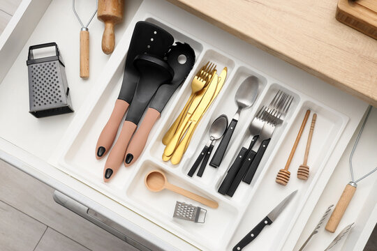 Organized kitchen drawer with assorted cooking utensils, cutlery, and gadgets for home cooking and culinary preparation