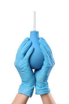 Medical enema bulb held by hands in blue latex gloves, healthcare and hygiene concept, isolated on white background