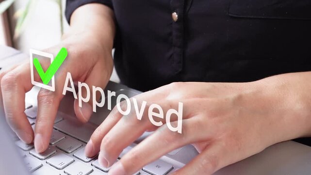 Close-up of female hands typing on a laptop with an animated checkmark and the word "approved"