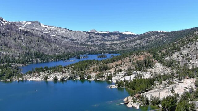 Echo Lakes and summit with desolation wilderness taken from a aerial point of view. The burn scars from the 2022 Caldor fire are evident and the forest hasn&rsquo;t recovered yet. Views also of  Lake Tahoe.