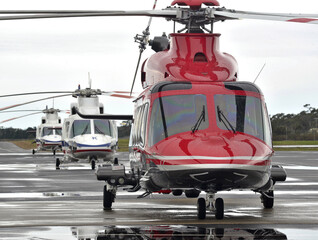Helicopters stand on the Helipad in Gippsland during a wet session, prior to transporting workers offshore. © KRUTOPIMAGES