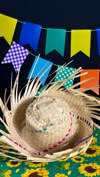 Brazilian June festival decoration. Colorful flags, straw hat and Brazilian flag.