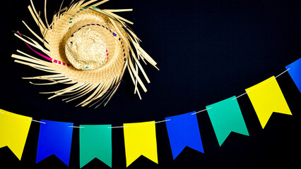 Brazilian June festival decoration. Colorful flags, straw hat and Brazilian flag.