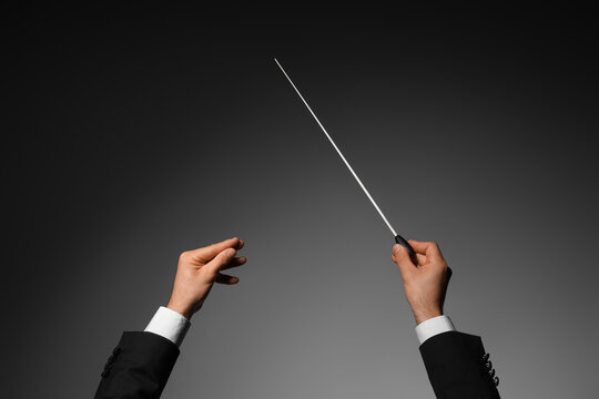 Male conductors hands on dark background