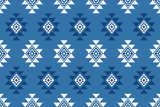 Beautiful seamless southwestern pattern featuring native american geometric diamond motifs in crisp white and navy on a blue background. Ideal for tribal blankets, rugs, and boho prints.