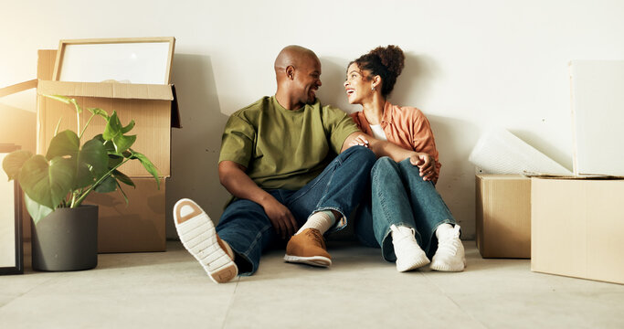 Couple, relax and moving in new home with boxes, property investment and happy for mortgage loan. Married, African people smile and bonding together in dream house with package, real estate and love.
