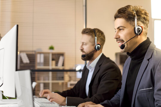 Men agents with headsets provide support. At office computers in a busy callcenter, operators assist a customer and monitor data to deliver consistent service. Lean B2B support concept now.
