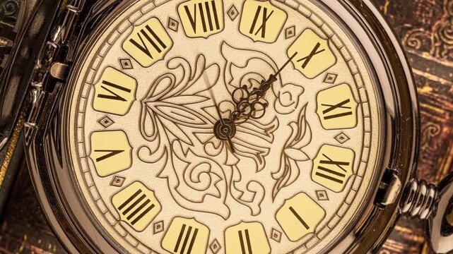 Vintage pocket watch rotating on antique book background showing roman numerals and floral engraving.