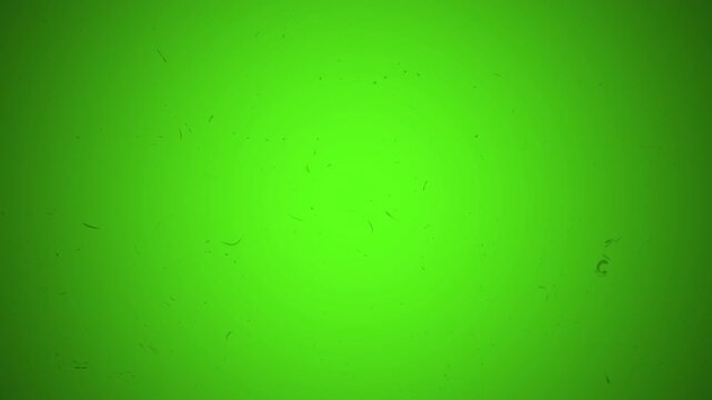 Old film tape texture with green color and grain particles, perfect for vintage or grunge design projects needing unique backgrounds.