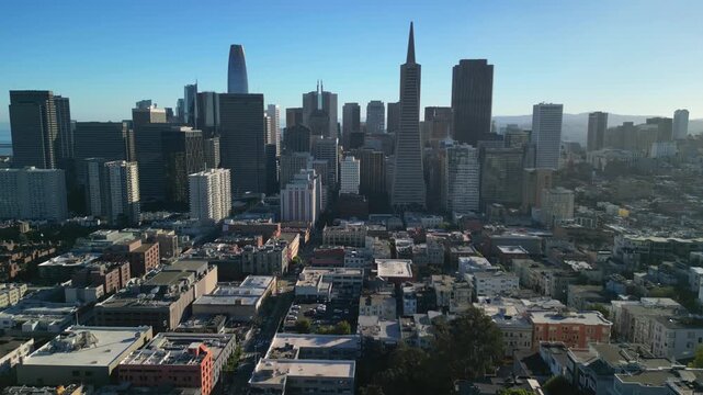 Aerial drone footage of Downtown San Francisco, California, featuring the city's iconic skyline, modern skyscrapers, bustling financial district, and urban landscape. Cinematic bird's-eye view showcas